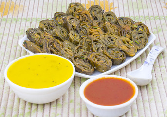 Indian Spicy Food Patra Also Called Paatra, Alu Vadi or Patrode is a Veg Dish in Maharashtra or Gujarati Cuisine. It is Made from Colocasia Leaves Stuffed with Rice Flour And Spices, Tamarind, Jaggery