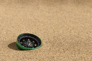 Fototapeta na wymiar Compass on sand