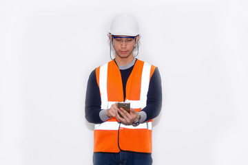Asian engineer wearing safety helmet and safety glasses holding smartphone on white background