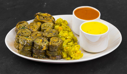 Indian Spicy Food Patra Also Called Paatra, Alu Vadi or Patrode is a Veg Dish in Maharashtra or Gujarati Cuisine. It is Made from Colocasia Leaves Stuffed with Rice Flour And Spices, Tamarind, Jaggery