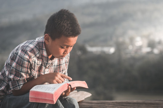 boy reading the scriptures.