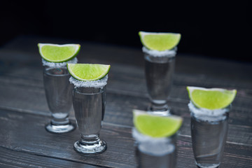 silver tequila on a black wooden background