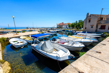 Fototapeta na wymiar Fishing boats moored in harbor or port on Silba, Croatia.