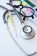 close up of stethoscope and thermometer for background
