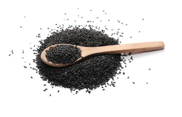 Black organic sesame seeds in wooden spoon isolated on white background