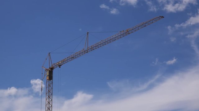 Time lapse footage of construction crane on building site, industrial machinery and equipment