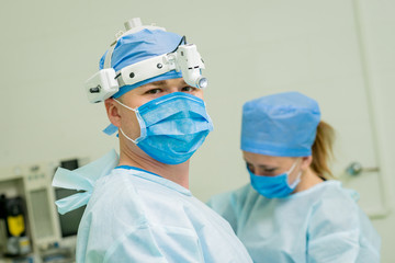 Portrait of surgeon in modern procedure room. Background