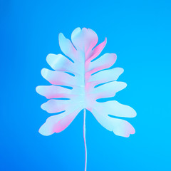 Tropical palm leaf in vibrant bold gradient holographic neon  colors. Concept art. Minimal surrealism summer background.
