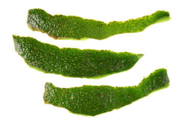 Long green skins from peeled ripe avocado