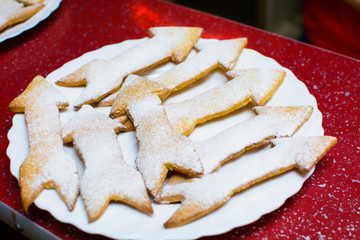 many cookies in the form of arrows on a plate