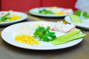 process of preparation of salad by the child at school of young cooks