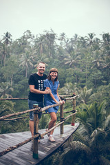 Traveler honeymoon couple in the jungle of Bali island, Indonesia. Couple in the rainforest.