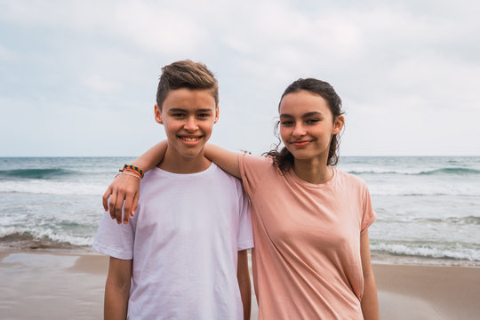 Two young friends on seashore background