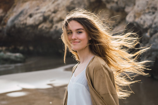 woman standing on the beach looking at the camera