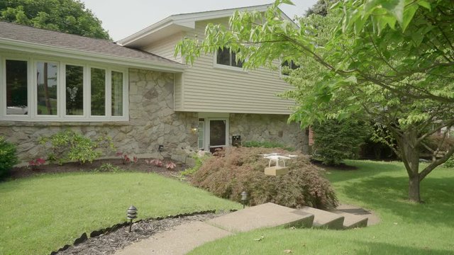 Small drone delivers a package to an American home