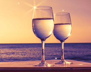 Two glasses of wine at sunset