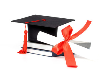 Graduation hat, book and diploma isolated on white background