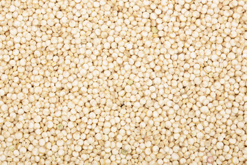 white quinoa seeds as a background. Top view