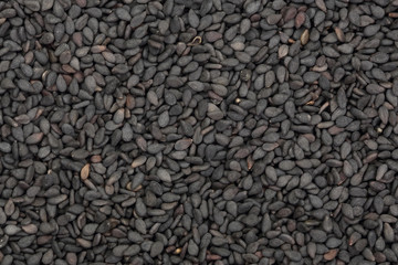Black sesame seeds isolated on white background top view