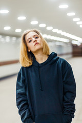 beautiful young blonde girl in an underpass