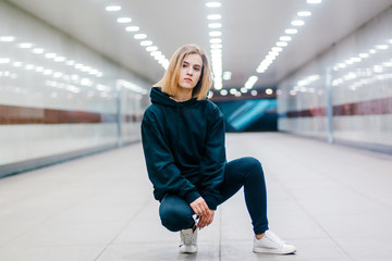 beautiful young blonde girl in an underpass