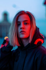 portrait of a girl in red blue in the street