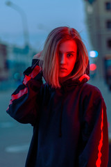 portrait of a girl in red blue in the street