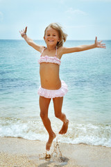 Little girl on the beach. Little girl posing in the sea.
