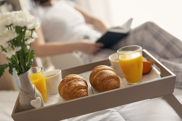 Woman reading a book before breakfast