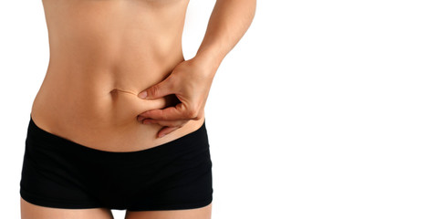 Fototapeta na wymiar Beautiful female stomach on a white background. Stretch on the abdomen. Female figure