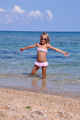 Little girl on the beach. Little girl posing in the sea.