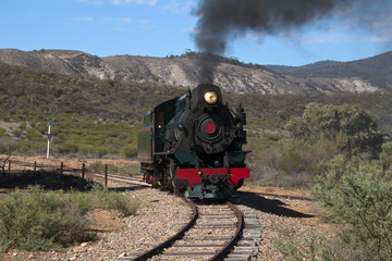 Fototapeta premium Quorn South Australia, View of approaching restored steam engine with semi arid landscape in background