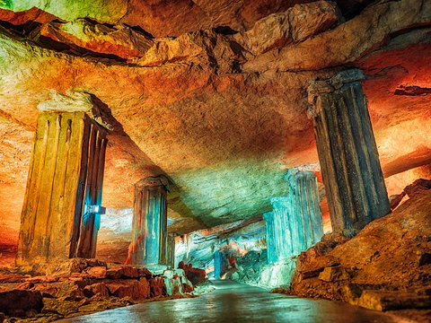 Wonderful Prometheus Cave. Stalactites and stalagmites in the illuminated cave