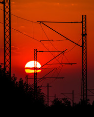 Railroad electricity supply network in red sunset