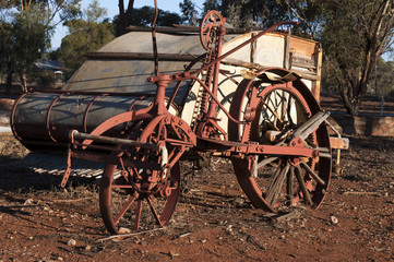 Fototapeta na wymiar Quorn South Australia, obsolete crop harvester left to rust in the afternoon sunlight