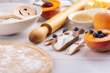 Fototapeta na wymiar Ingredients for baking fruit pie on white table.