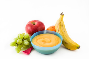 Baby food: colorful bowl of fruit puree isolated on white background