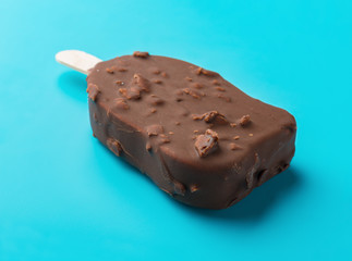 side view chocolate outer ice cream starts melting on a blue background