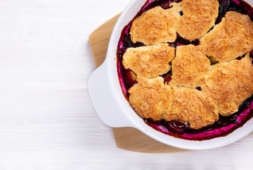 Freshly baked peach and blueberry cobbler. Homemade fruit pie.