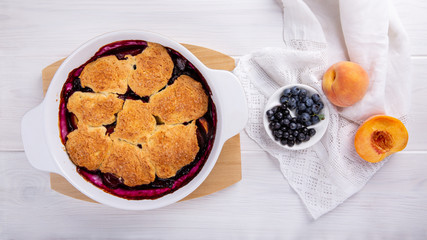Freshly baked peach and blueberry cobbler. Homemade fruit pie.