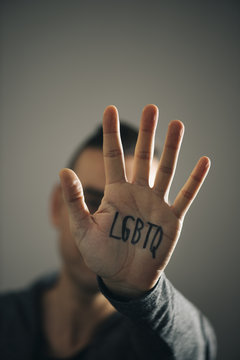 man with the text LGBTQ in his hand