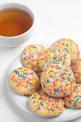 Cookies with colorful sprinkles and tea