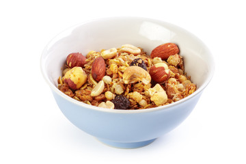 Bowl of homemade granola with fruit pieces isolated on white