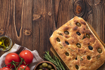Traditional Italian Focaccia with olives, rosemary - homemade flat bread focaccia. Rustic style. Top view.
