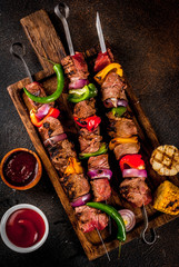 Fresh, home-cooked on the grill fire meat beef shish kebab with vegetables and spices, with...