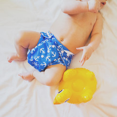 Baby ready for summer vacation. Closeup, high angle, matte filter, natural light, square format
