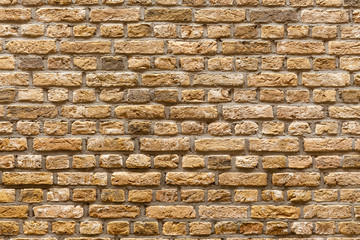 Close-up white yellow and brown old brick wall