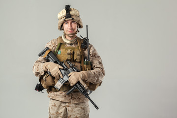 Soldier in camouflage holding rifle