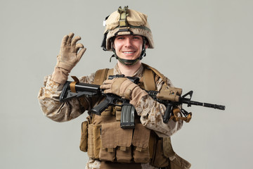 Soldier in camouflage holding rifle