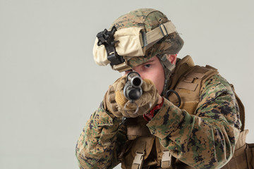 Soldier in camouflage holding rifle